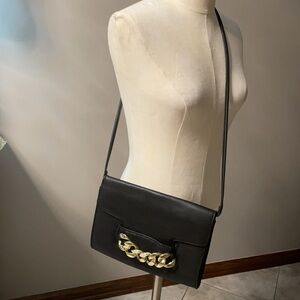 H & M black crossbody with bold gold chain front accent.